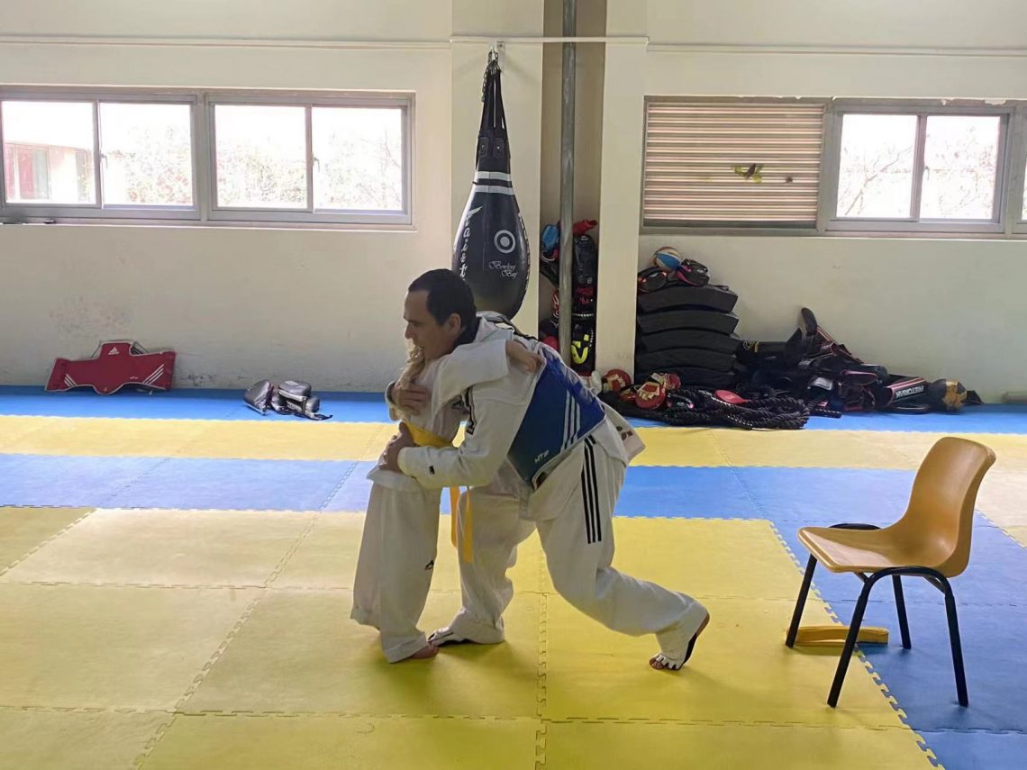 Taekwondo Coach hugging my daughter who passed her yellow belt