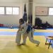 Taekwondo Coach hugging my daughter who passed her yellow belt